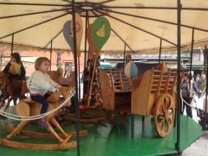 Elsa on the carousel...see the man behind the balloon?