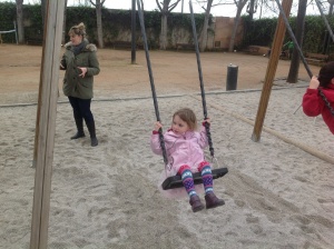 Elsa swinging at the park.